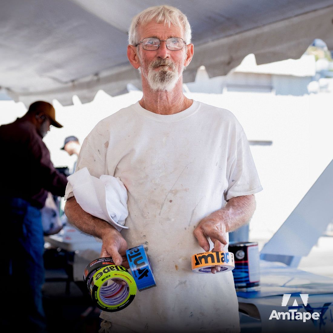 A painter holding AmTape tapes